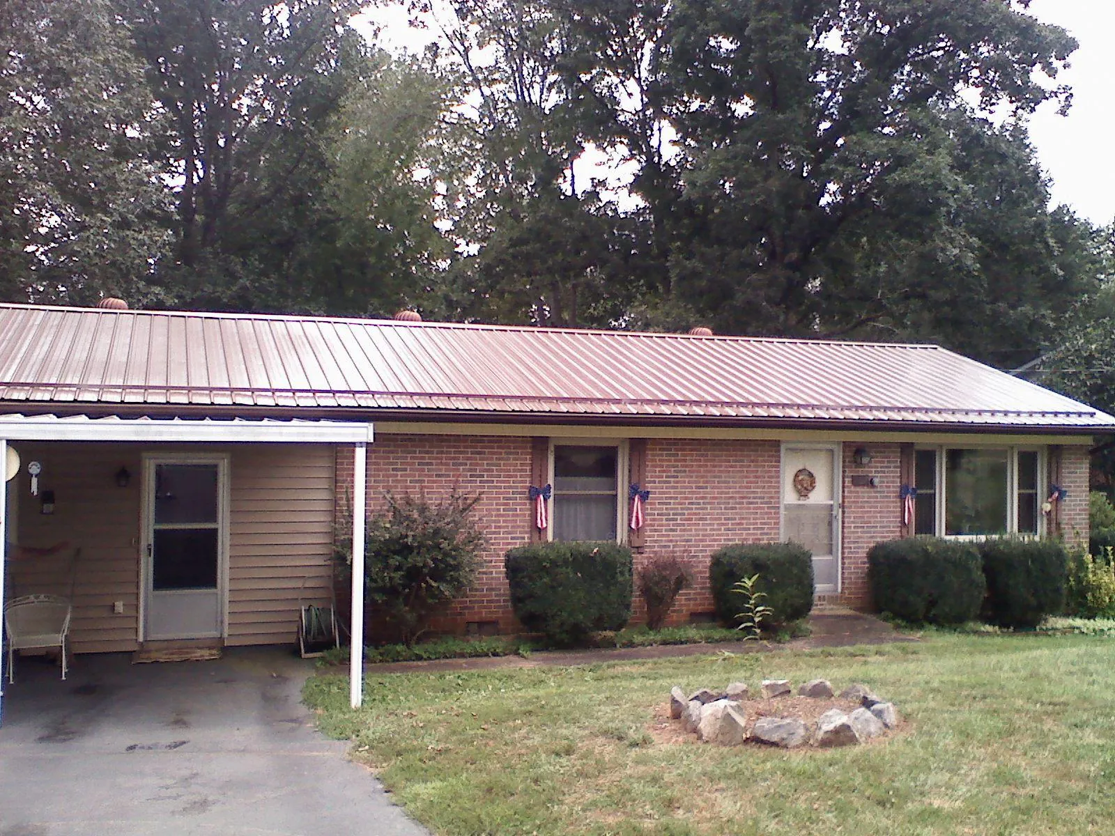 Bronze metal roof and carport on a brick ranch home — Roof Repair work by our crew in Mohler