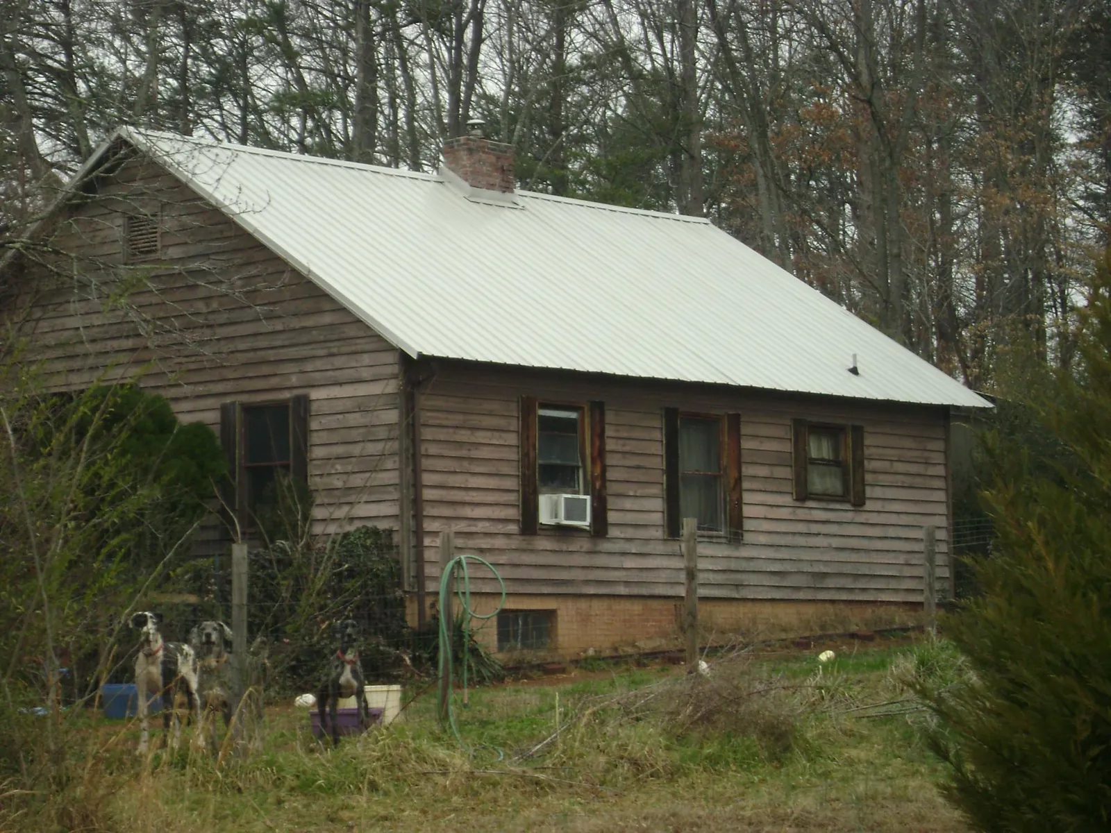White metal roof on an old wood sided farmhouse, from a Metal Roof Installation job in Mohler